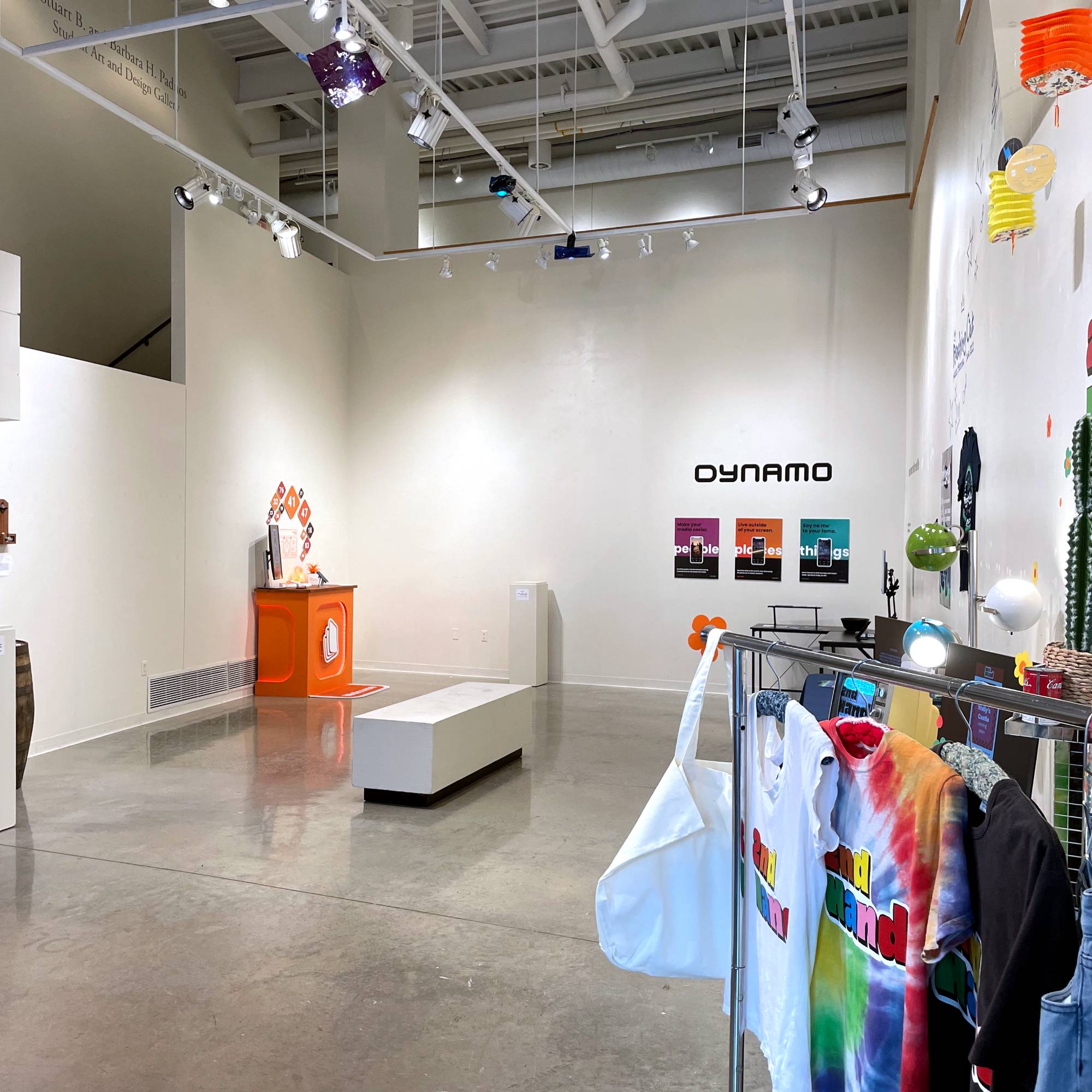 Brightly colored clothing BFA Graphic Design displays within the Padnos Student Gallery.